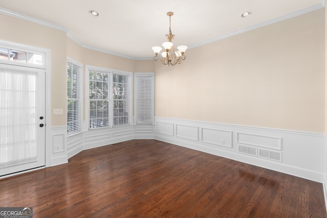 unfurnished dining area featuring ornamental molding, an inviting chandelier, and dark hardwood / wood-style flooring