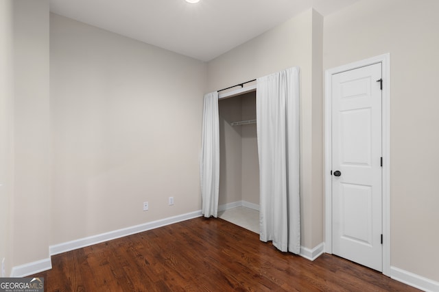 unfurnished bedroom featuring dark wood-type flooring