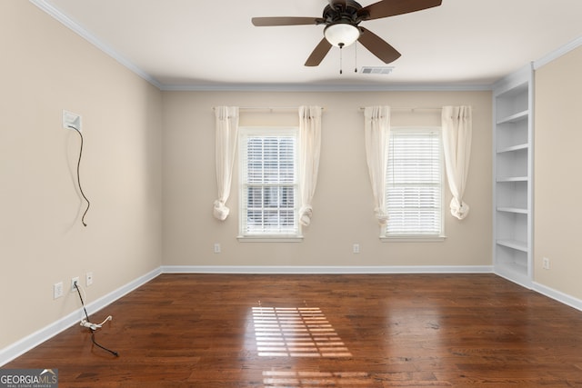 empty room featuring dark wood-type flooring, ceiling fan, crown molding, and plenty of natural light