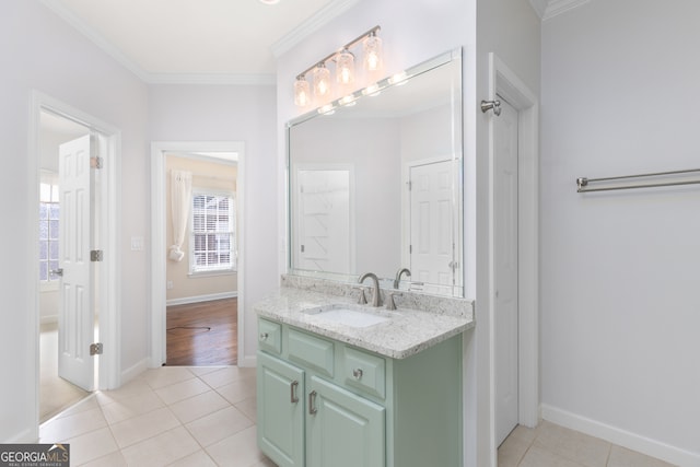 bathroom with vanity, ornamental molding, and tile patterned flooring