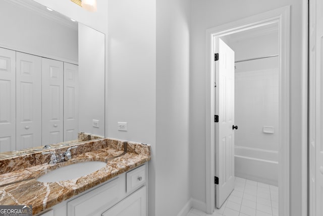 bathroom featuring vanity, ornamental molding,  shower combination, and tile patterned flooring