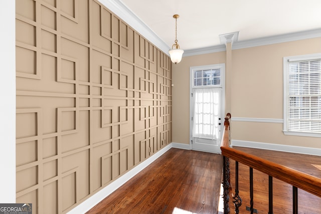 interior space with ornamental molding and dark hardwood / wood-style floors