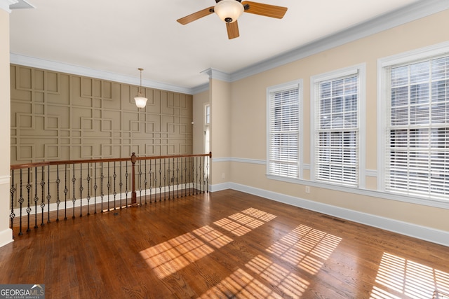 unfurnished room featuring ceiling fan, wood-type flooring, and ornamental molding