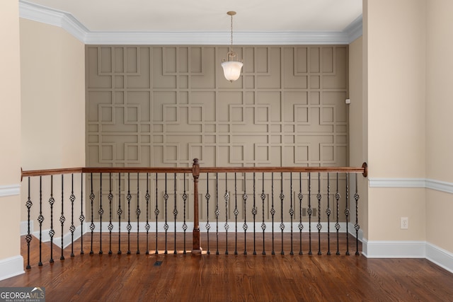 unfurnished room featuring crown molding and wood-type flooring