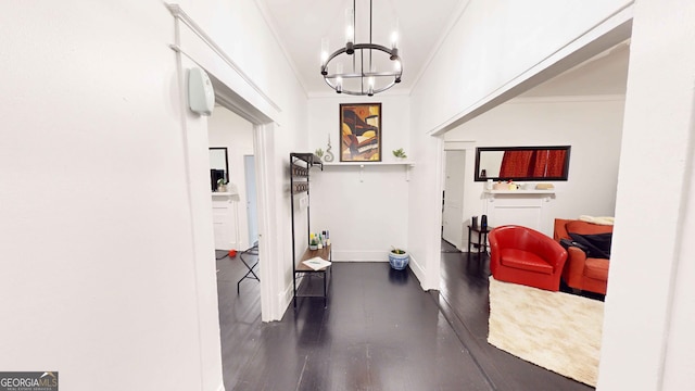 corridor with a notable chandelier, ornamental molding, and dark hardwood / wood-style floors