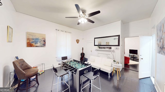 rec room with ceiling fan and dark hardwood / wood-style flooring