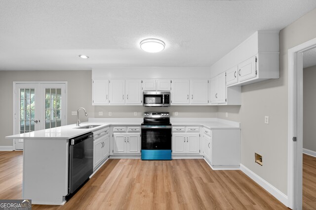 kitchen featuring sink, kitchen peninsula, stainless steel appliances, white cabinets, and light hardwood / wood-style flooring