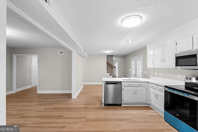 kitchen featuring white cabinetry, light hardwood / wood-style floors, stainless steel appliances, and sink