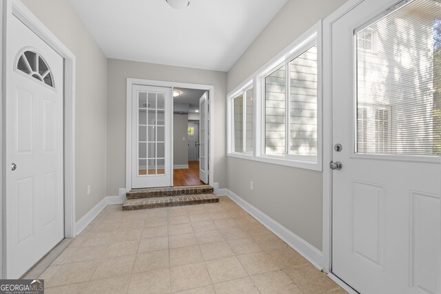 doorway with light tile patterned flooring