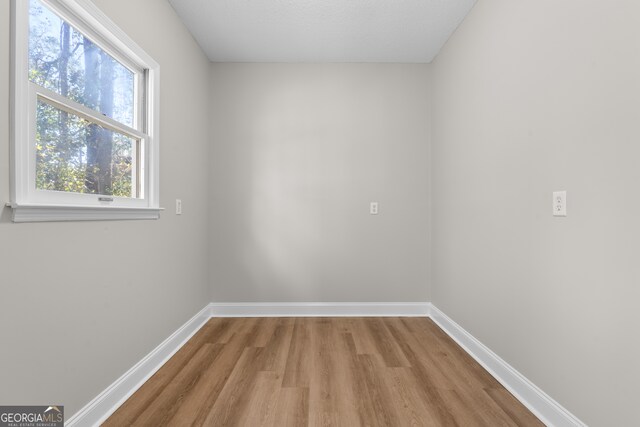 unfurnished room with light hardwood / wood-style flooring