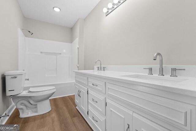 full bathroom featuring vanity, shower / bathing tub combination, toilet, and hardwood / wood-style flooring