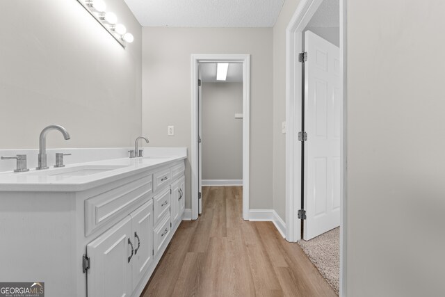 bathroom featuring vanity, a textured ceiling, and wood-type flooring