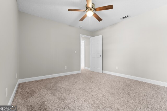 carpeted empty room featuring a textured ceiling and ceiling fan