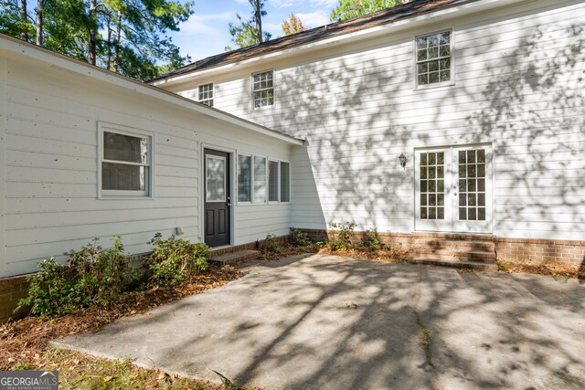 rear view of house with french doors and a patio