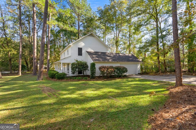 view of side of property with a yard