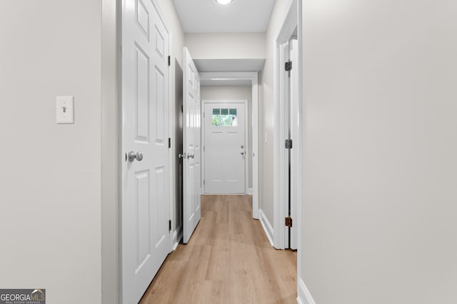 hallway with light hardwood / wood-style flooring