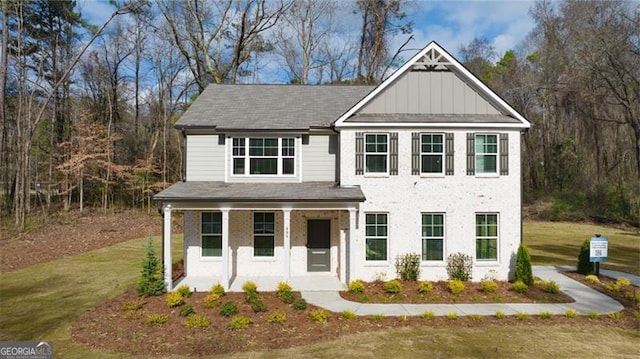 view of front of home with a porch and a front yard