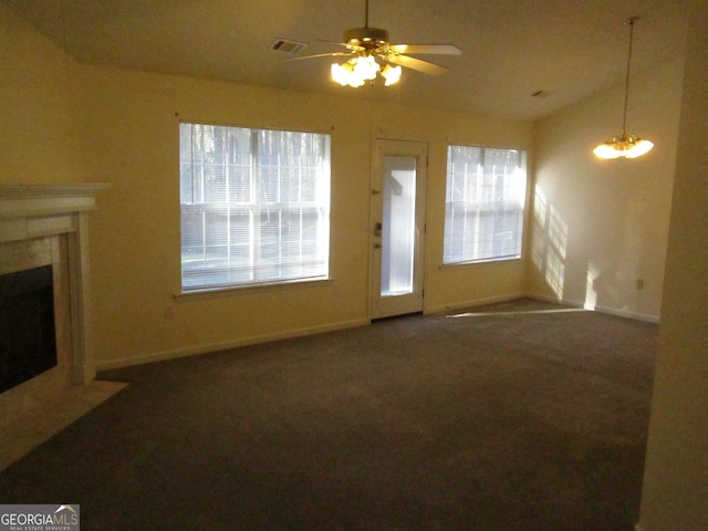 carpeted living room featuring ceiling fan with notable chandelier