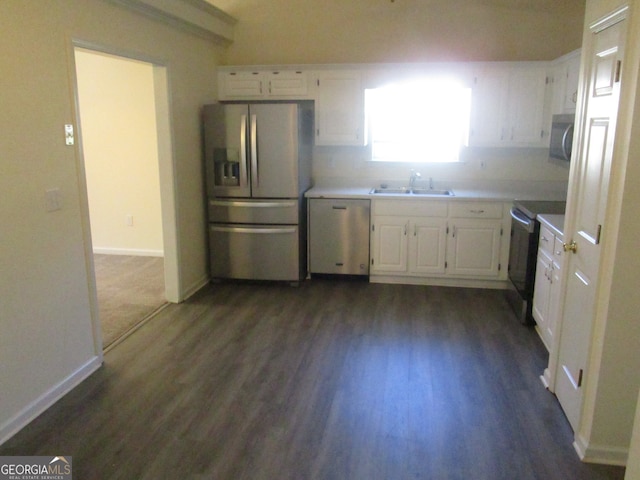 kitchen with appliances with stainless steel finishes, white cabinets, sink, and dark hardwood / wood-style floors