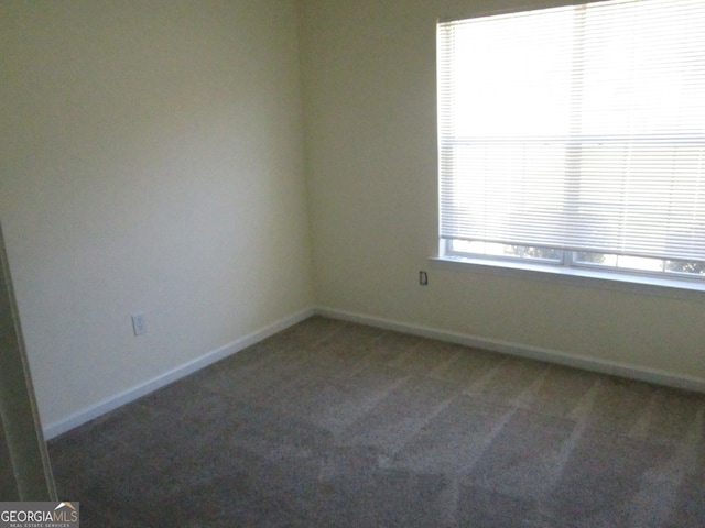 empty room featuring dark carpet