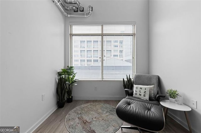 living area with hardwood / wood-style floors