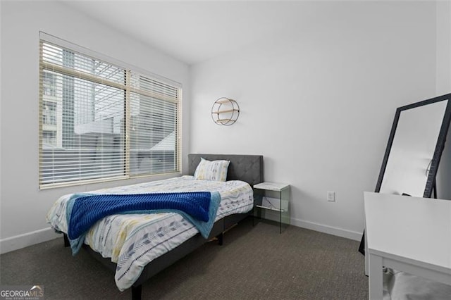 bedroom with dark colored carpet