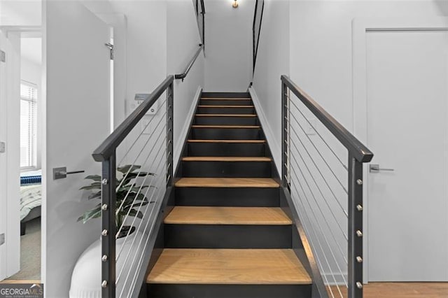 stairs featuring wood-type flooring