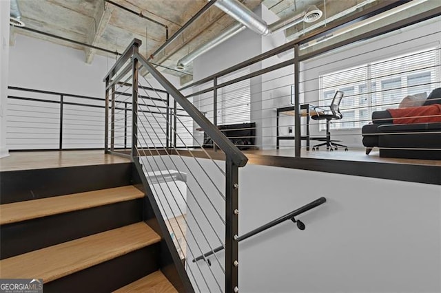 staircase with hardwood / wood-style flooring