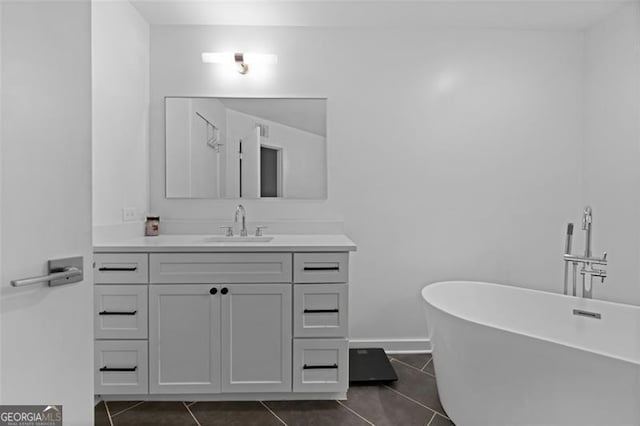 bathroom with vanity, tile patterned flooring, and a washtub