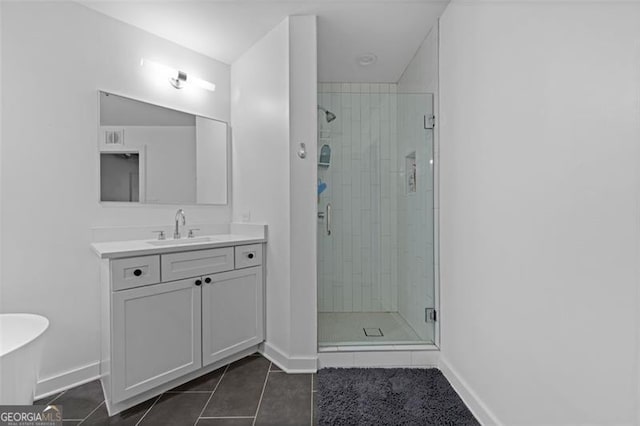 bathroom featuring vanity, tile patterned flooring, and walk in shower