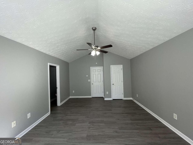 interior space featuring a textured ceiling, ceiling fan, vaulted ceiling, and dark hardwood / wood-style flooring