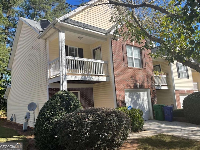 view of home's exterior with a balcony and a garage