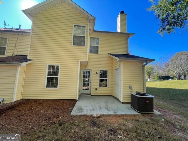 back of property featuring a patio area, central AC unit, and a lawn