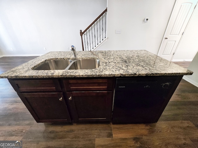 kitchen with black dishwasher, sink, an island with sink, and dark hardwood / wood-style floors