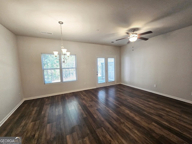 spare room featuring dark hardwood / wood-style floors and ceiling fan with notable chandelier