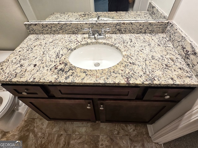 bathroom featuring vanity and toilet