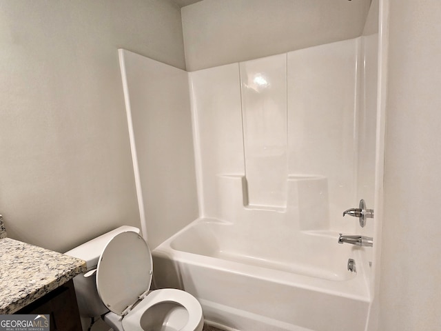 full bathroom featuring vanity, washtub / shower combination, and toilet