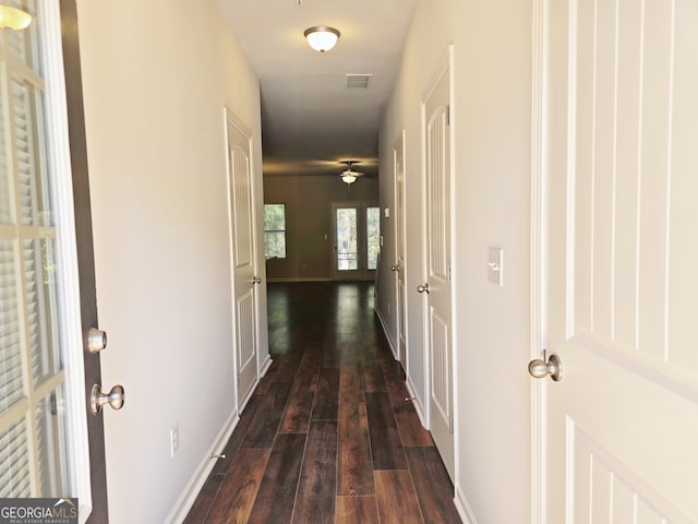 hallway featuring french doors and dark hardwood / wood-style flooring