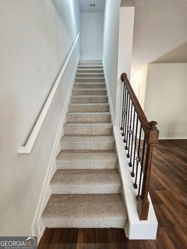 staircase featuring hardwood / wood-style floors