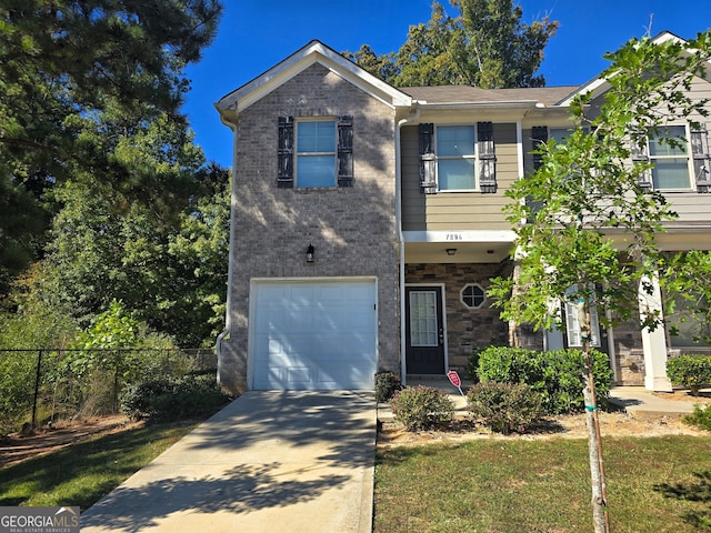 view of front facade with a garage and a front lawn