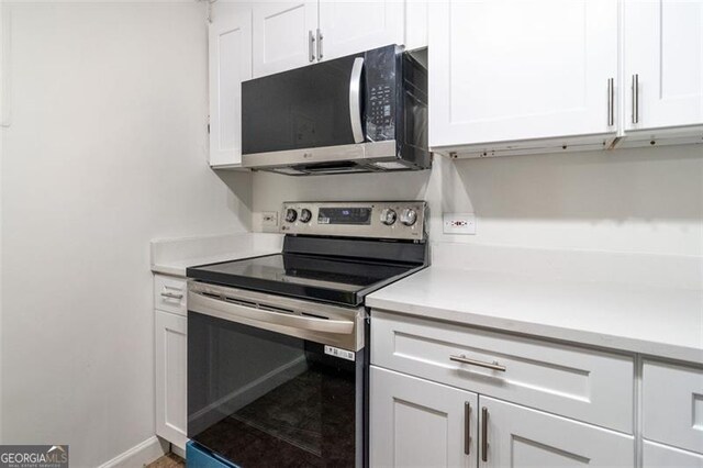 kitchen featuring white cabinetry and stainless steel appliances