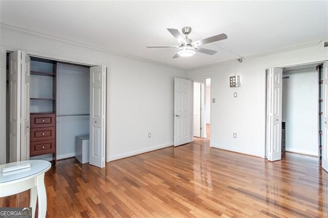 unfurnished bedroom with ceiling fan and hardwood / wood-style flooring