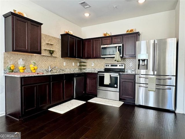 kitchen with tasteful backsplash, light stone countertops, sink, dark hardwood / wood-style flooring, and stainless steel appliances