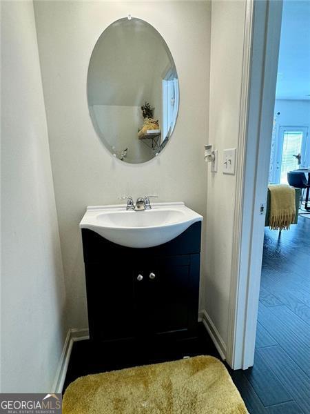 bathroom with vanity and hardwood / wood-style flooring