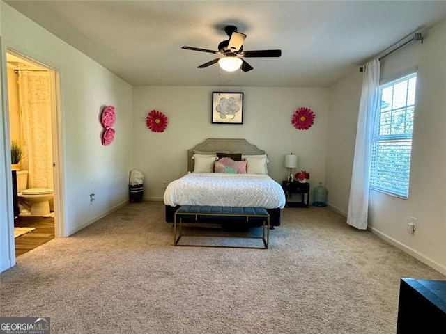 carpeted bedroom featuring connected bathroom and ceiling fan