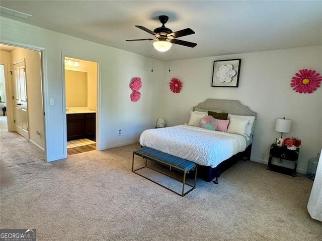 carpeted bedroom featuring ensuite bathroom and ceiling fan