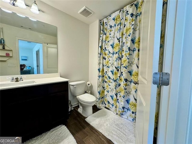 bathroom with vanity, a shower with curtain, hardwood / wood-style flooring, and toilet