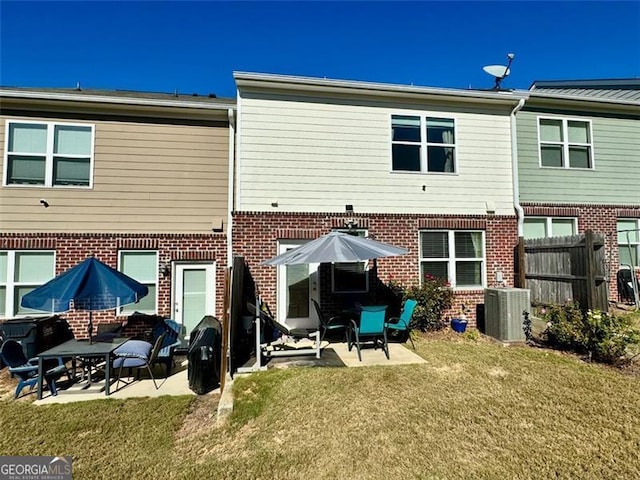 back of property featuring central AC unit, a patio, and a lawn