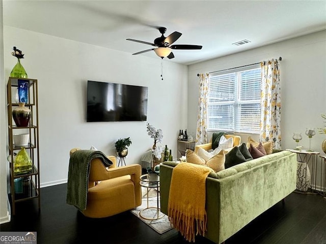 living room featuring ceiling fan and dark hardwood / wood-style flooring