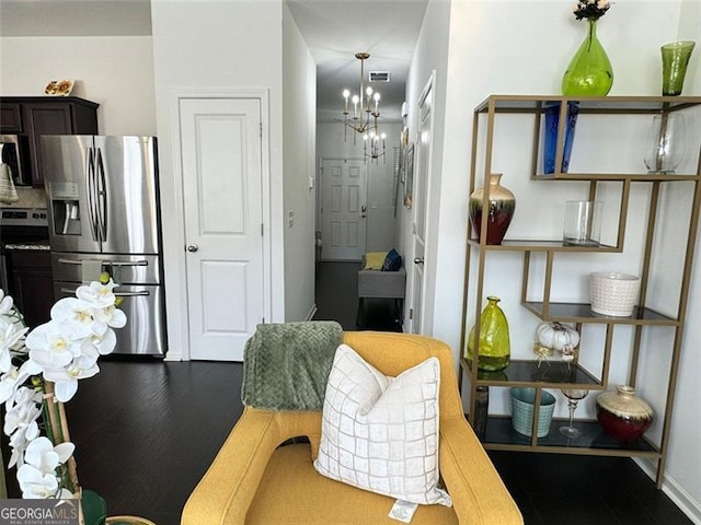 interior space with an inviting chandelier and hardwood / wood-style floors